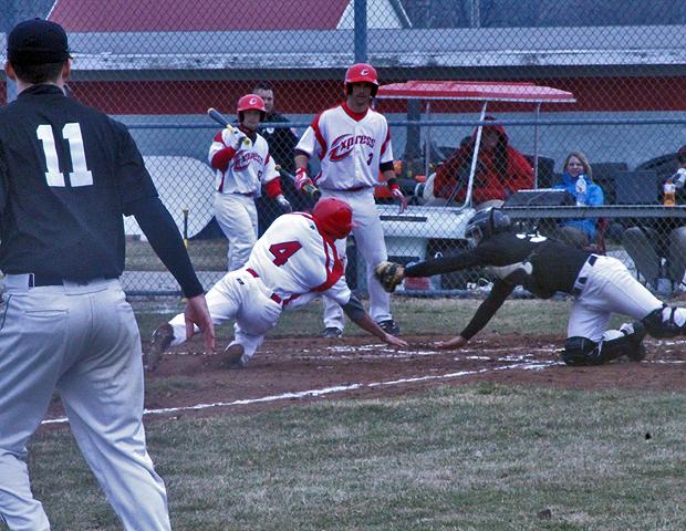 Nate Manis eludes a third inning tag to give the Express a 1-0 lead. Justin Elder (3) and Alex Samson (12) watch from the background. Photo by Dave Harrand/Owens Sports Information