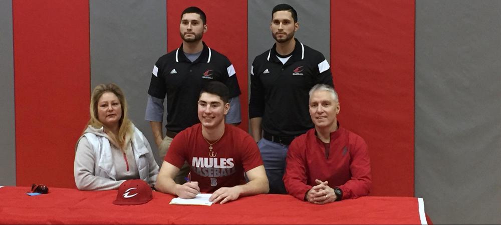 Tanner Glass, front center, is pictured after signing his letter of intent. Photo by Owens Sports Information
