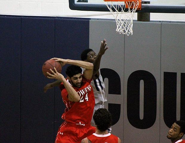 Bikramjit Gill pulls down a rebound over Columbus State's Christopher Cook in today's 84-76 Express win, in which Gill produced 12 points and 21 rebounds. Photo by Geoff Roberts/Owens Sports Information