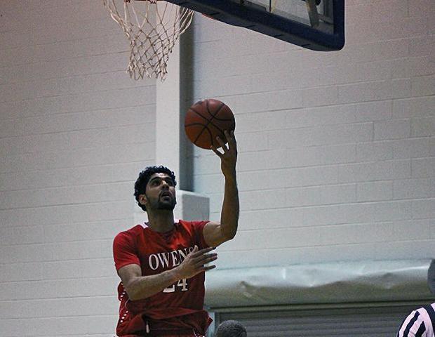 Bik Gill scores two of his points in today's 105-70 win over Edison Community College. Photo by Geoff Roberts/Owens Sports Information