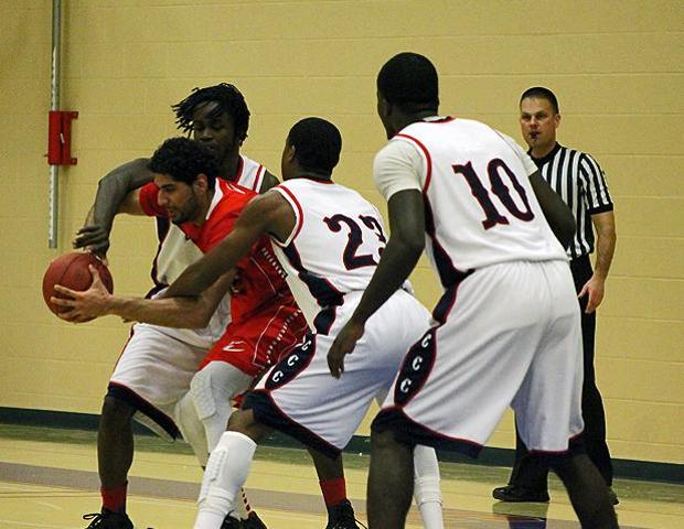 Bik Gill (29 points, 13 rebounds) battles for possession of the ball in tonight's 87-72 win over Cuyahoga Community College. Photo by Nicholas Huenefeld/Owens Sports Information
