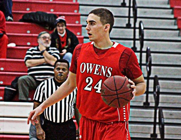 Pete Firlik, wearing the red uniform at home, had 10 points as the No. 12 Owens men's basketball team upset No. 5 Mott in the SHAC tonight. Photo by Nicholas Huenefeld/Owens Sports Information