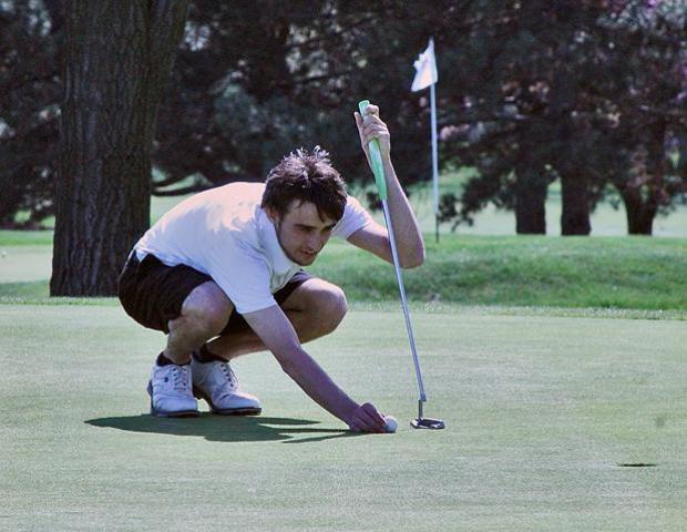 Walter Dorosh checks out the conditions on the green at today's Owens Invitational. His 73 was one stroke out of first place. Photo by Rudy Yovich/Owens Sports Information