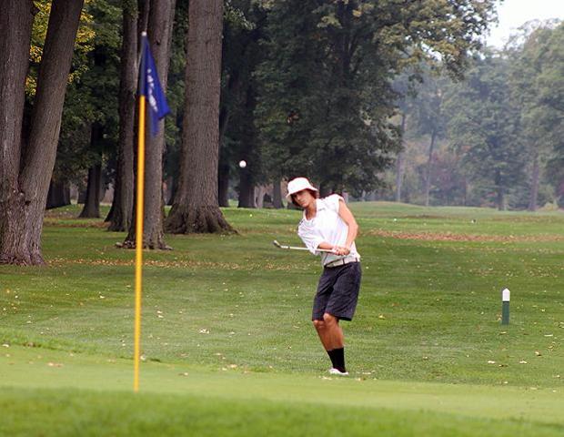 Brandon Hoelzer attempts a shot on the second playoff hole in today's Owens Invitational. The sophomore finished in a tie for first, but lost in a playoff for medalist honors. He led his team to a first place finish, though. Photo by Nicholas Huenefeld/Owens Sports Information
