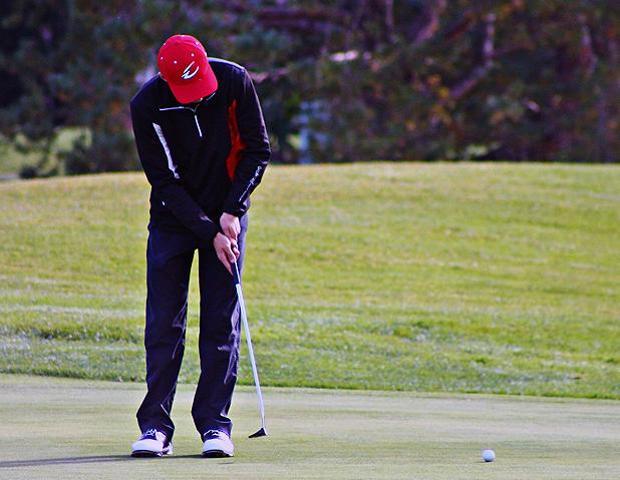 Dominic DiGiacomo watches his putt move toward the hole on the 18th green in today's Owens match play tournament. Photo by Nicholas Huenefeld/Owens Sports Information