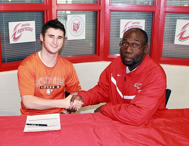 Jacob Martin, left, celebrates his letter of intent signing with Express men's soccer head coach Art Johnson. Photo by Nicholas Huenefeld/Owens Sports Information