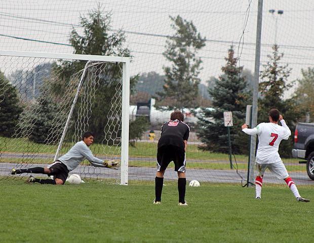 Jake Martin beats Lake Michigan's goalkeeper Danny Martinez on the right side of the net for a penalty kick goal in today's 3-2 loss for the Express. Photo by Nicholas Huenefeld/Owens Sports Information