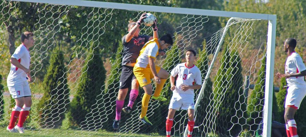 Kyle Rowan makes a save in traffic for Owens. Photo by Nicholas Huenefeld/Owens Sports Information