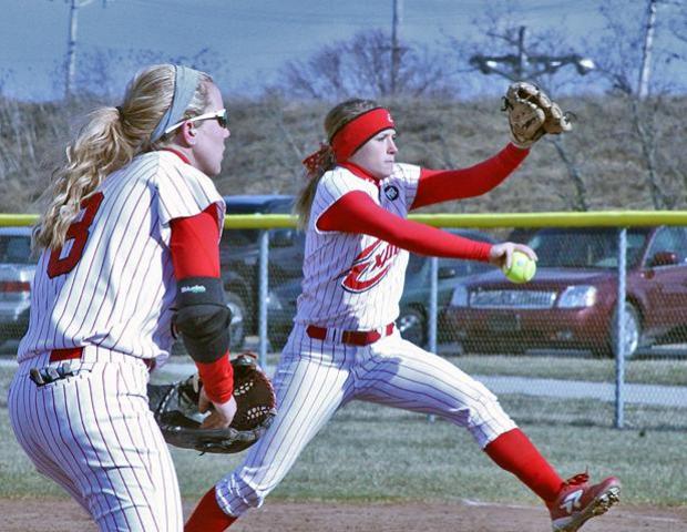 Amanda Sinay delivers a pitch for the Express in today's doubleheader as Emily Rockman prepares for a possible grounder. It was Sinay's collegiate pitching debut. Photo by Nicholas Huenefeld/Owens Sports Information