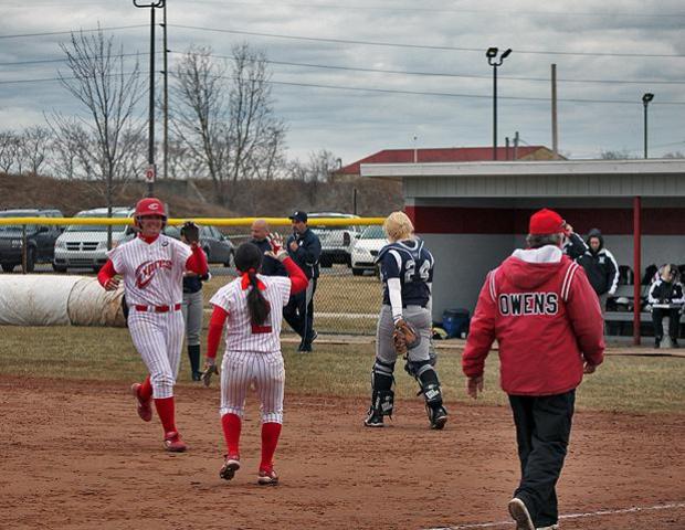 Katie Butler, far left, is congratulated by Olivia Reeder after getting the game winning, walk-off single up the middle to defeat Macomb 5-4 in today's second game. Photo by Dave Harrand/Owens Sports Information