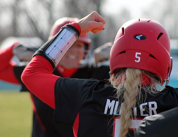 With Emily Mutter looking on, Aubrey Geis flexes after rounding the bases following her three-run homer in today's second game. Photo by Nicholas Huenefeld/Owens Sports Information
