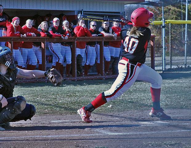 Brittany George watches her first inning home run sail over the fence in today's doubleheader split with No. 8 Mercyhurst North East today. Photo by Geoff Roberts/Owens Sports Information