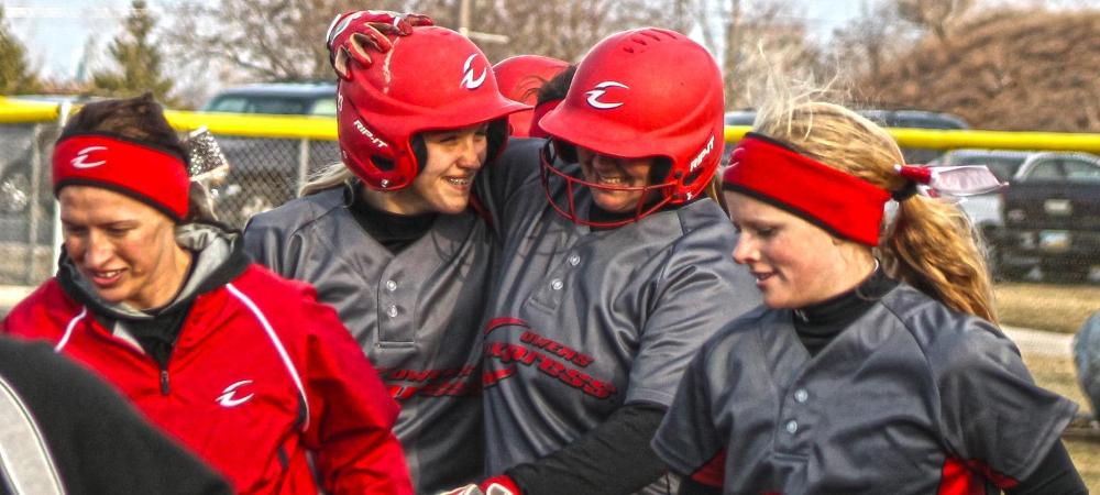 Tori Weidinger (center) is congratulated by Josie Hall to her right following her second home run of the day against Walsh. Photo by Nicholas Huenefeld/Owens Sports Information