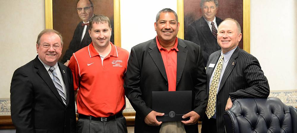 Pictured from L to R are: Owens President Dr. Mike Bower, Owens head men's basketball coach Dave Clarke, Owens head women's basketball coach Mike Llanas and Owens Chair for the Board of Trustees Rich Rowe