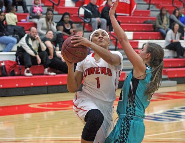 Briana Williams goes in for a lay-up against Cuyahoga's Danielle Lasky. Williams finished with a season-high 14 points. Photo by Tobias Flemming/Owens Sports Information