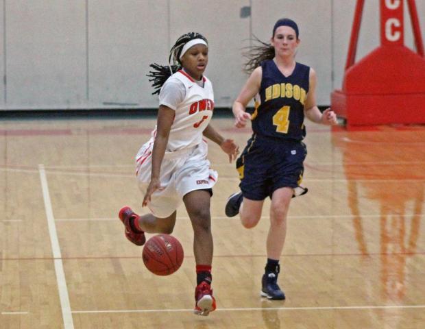 Courizma Williams brings the ball up the court as Edison's Brooke Dunlevy chases her. Williams had a game-high 22 points in today's win. Photo by Tobias Flemming/Owens Sports Information