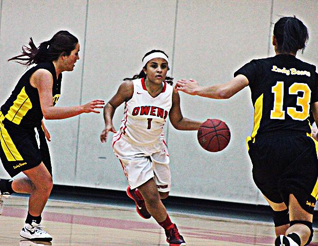 Briana Williams looks to advance the ball during the second half of tonight's 80-56 win over Mott. Photo by Nicholas Huenefeld/Owens Sports Information