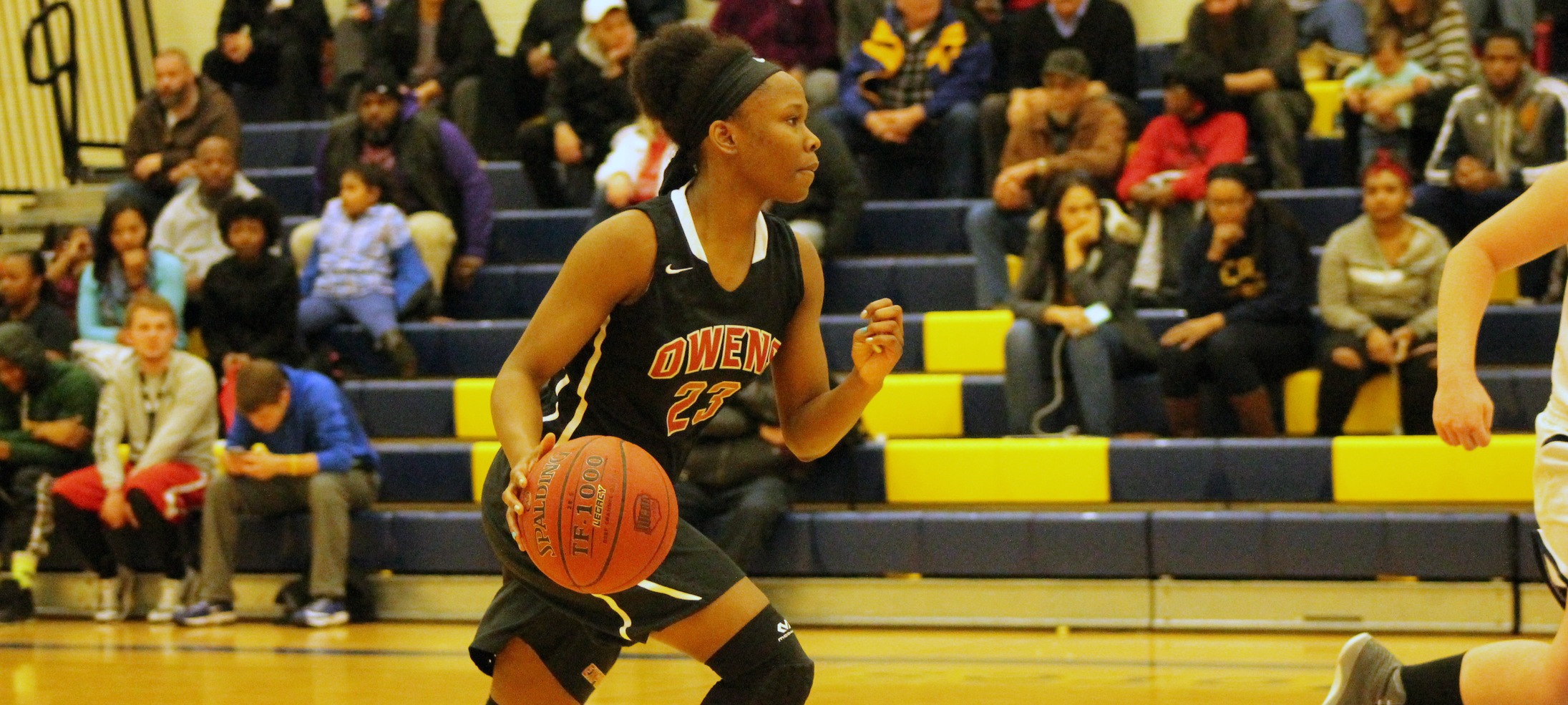 Denissa Sly brings the ball up the court against Lorain County. Photo by Nicholas Huenefeld/Owens Sports Information