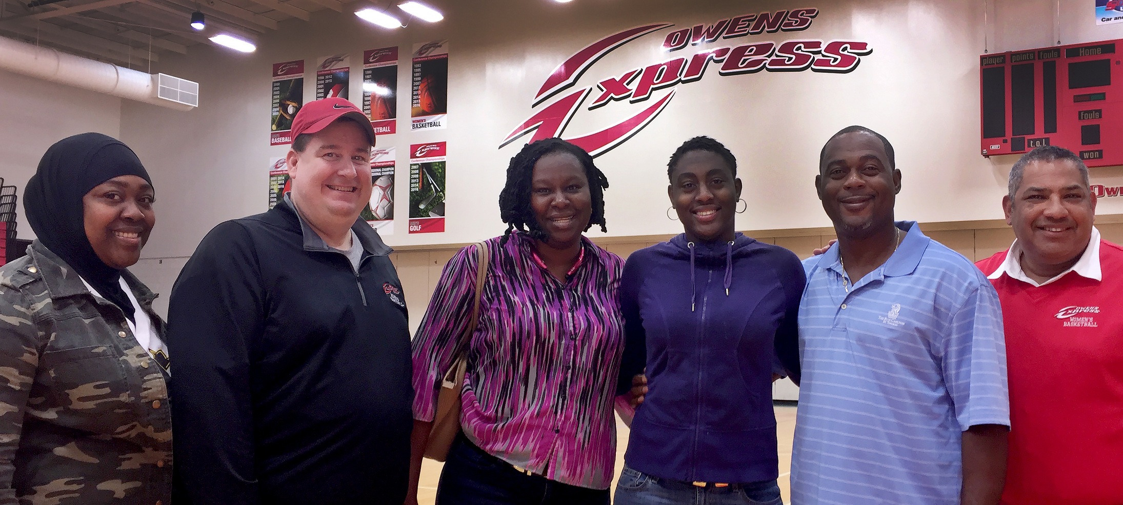 Alexis Boston, third from the right, is pictured with her parents and the Owens women's basketball coaching staff. Photo by Owens Sports Information