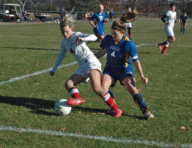 Jill Burkholder makes a move against a Muskegon defender in today's Region XII semifinal. Photo by Nicholas Huenefeld/Owens Sports Information