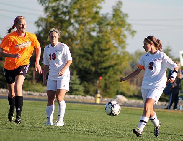 Abby Groll plays a ball while Haley Malaczewski looks on. Photo by Nicholas Huenefeld/Owens Sports Information