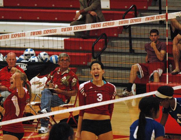 Alyssa Meis celebrates a kill late in the match against Cuyahoga, which was a three set win for the No. 5 Express. Brandi Schimming, far left, is also show celebrating. Photo by Nicholas Huenefeld/Owens Sports Information