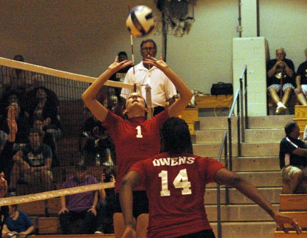 Molly Hilfinger looks to make one of her 33 assists against Edison Community College. She totaled 69 assists in two matches this weekend. Photo by Nicholas Huenefeld/Owens Sports Information