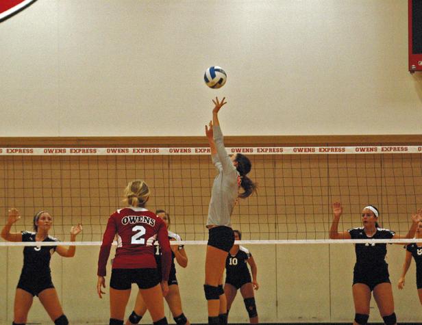 Molly Hilfinger sets the ball for one of her single match program record 64 assists last night against Sinclair CC. Photo by Nicholas Huenefeld/Owens Sports Information