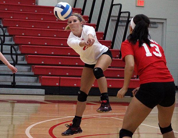 Lisa Urbanski (in white) digs a ball during today's second match against Jackson College. The sophomore totaled 50 digs in today's action. Photo by Nicholas Huenefeld/Owens Sports Information