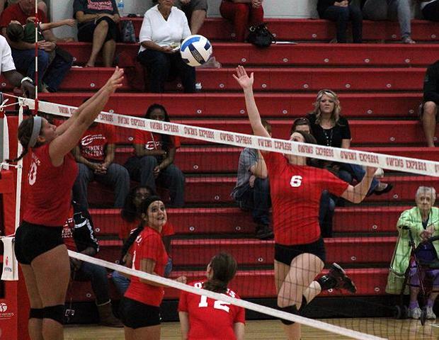 Stephanie Kipp (16 kills, right) plays a ball at the net against Sinclair's Jessica Thobe in today's four-set loss for the Express. Photo by Nicholas Huenefeld/Owens Sports Information