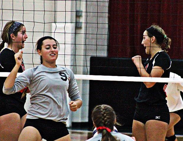 Macy Reigelsperger and Ally Mikesell (L to R) celebrate a point against Sinclair Community College. Photo by Nicholas Huenefeld/Owens Sports Information