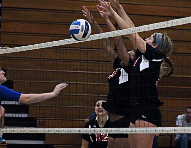 Macy Reigelsperger (right) and Amara Hemenway team up to block a Lakeland attack in tonight's match. Photo by Nicholas Huenefeld/Owens Sports Information