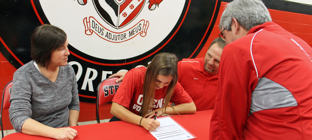 Cassidy Wlodarz signs her LOI as her parents and Owens volleyball head coach Sonny Lewis look on. Photo by Nicholas Huenefeld/Owens Sports Information