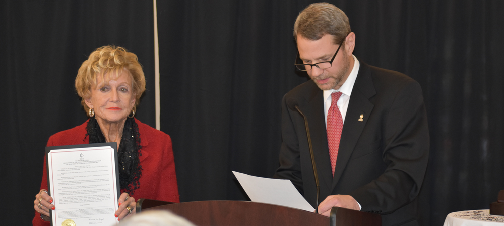 Owens President, Dr. Steve Robinson, reads a proclamation from the Owens Board of Trustee, while Board Chairman, Diana Talmage, looks on.