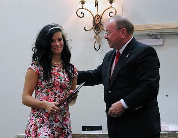 Jessica Grindle accepts her Owens Female Athlete of the Year award from Owens President Dr. Mike Bower at last night's athletic awards banquet. Photo by Nicholas Huenefeld/Owens Sports Information
