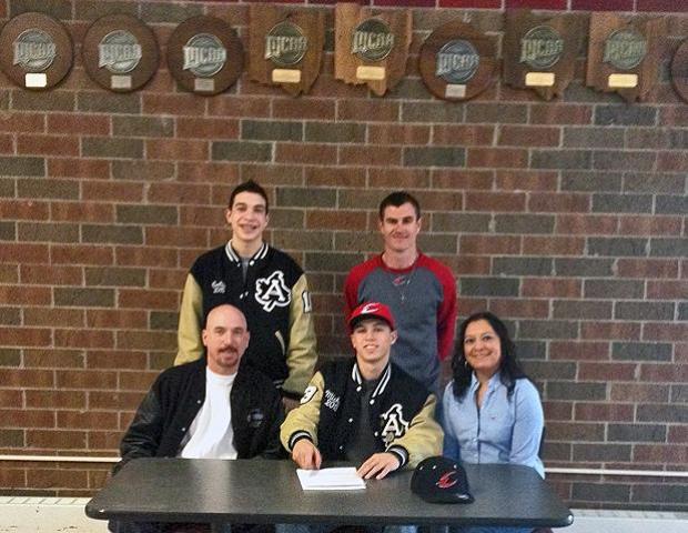 Michael Hamden Jr., front center, is surrounded by his parents, his brother and Express head baseball coach Devin Taylor just after signing his letter of intent. Photo by John Parisho/Owens Sports Information