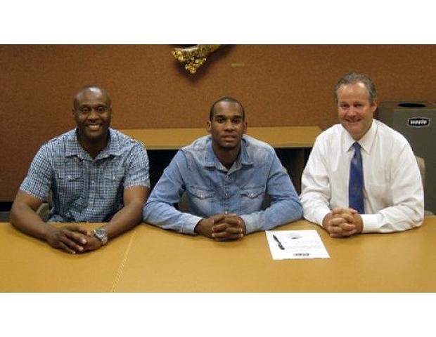 Nick Collins is pictured here after signing with Purdue University North Central. To his left is his dad, Romelle, while Purdue University North Central head coach John Weber. Photo by PNCathletics.com