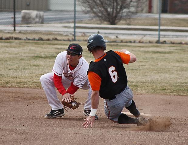 Alec Skender snares a throw from catcher Austin Legate before applying the tag for an out in today's first game against Heidelberg JV. Photo by Nicholas Huenefeld/Owens Sports Information