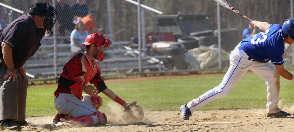 Nolan Rao catches a breaking ball in the dirt as the batter swings and misses. Photo by Frank Rao Jr./Owens Sports Information