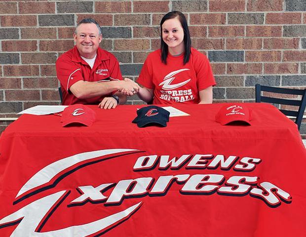 Cassidy Rolf shakes hands with Express softball head coach Duane Lanham after signing her letter of intent today. Photo by Geoff Roberts/Owens Sports Information