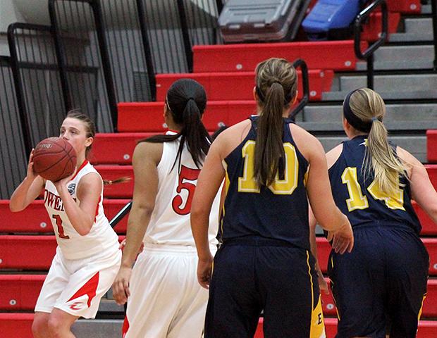 Paige Wright (far left) prepares to attempt a 3-pointer in the second half of tonight's win over Edison as Kamilah Carter (5) looks on. Wright finished just one assist shy of a triple-double. Photo by Nicholas Huenefeld/Owens Sports Information